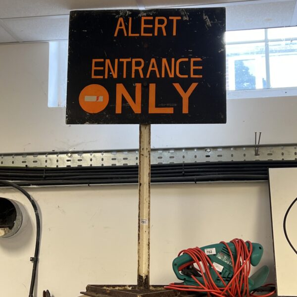 Vintage entrance alert sign with red circle and white background.