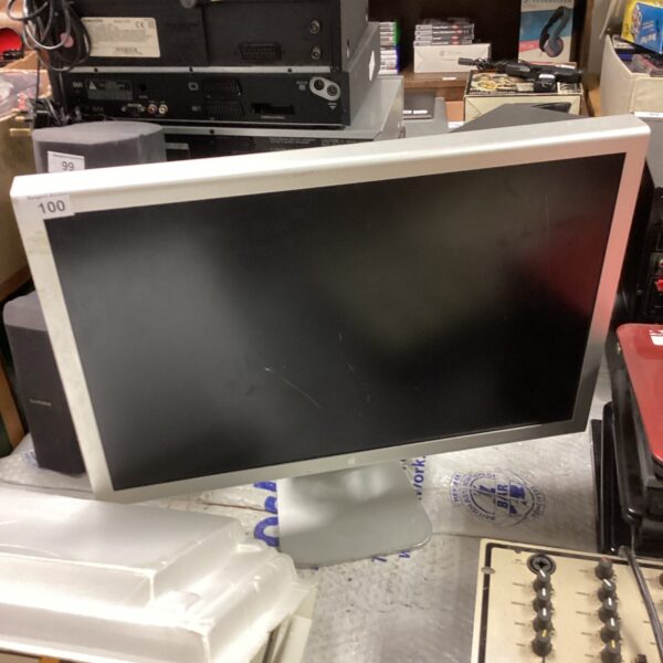 Vintage CRT computer monitor with other electronics in background.