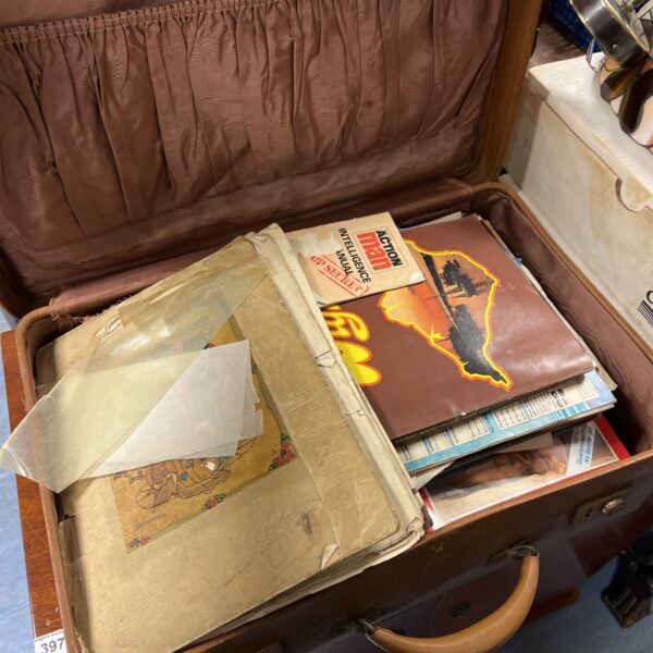 Vintage steamer trunk with faded canvas and metal clasps.