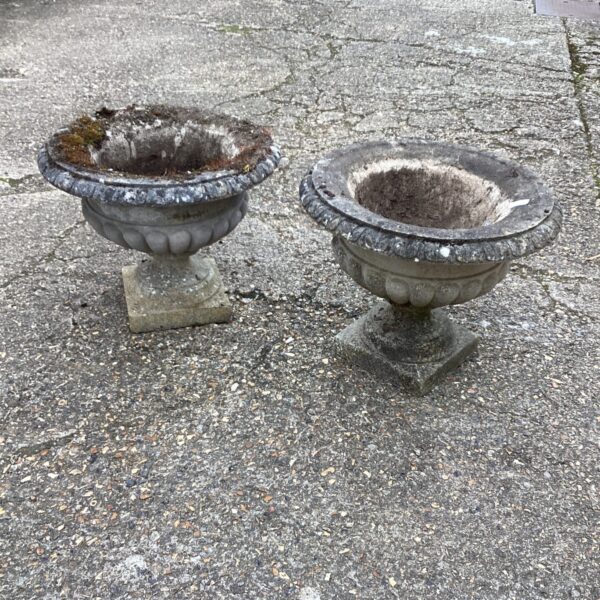 Weathered stone garden planter with moss and lichen growth.