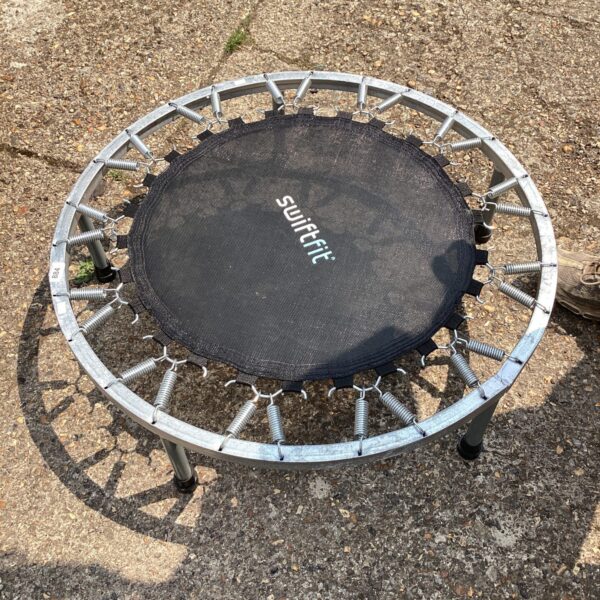 Black mini trampoline for indoor fitness and rebounding exercise.