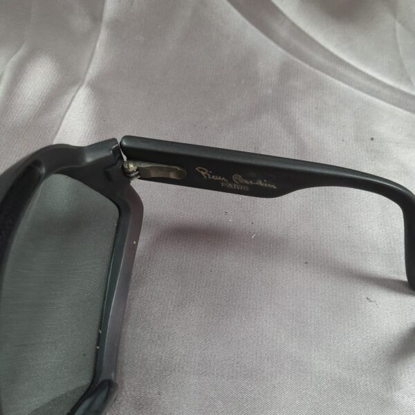 Close-up of vintage cat eye sunglasses with dark lenses.