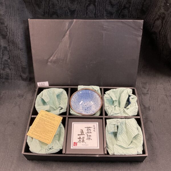 Antique Japanese Imari tea bowl with blue floral pattern.