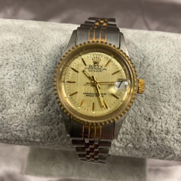 Vintage Rolex Datejust watch with stainless steel bracelet.