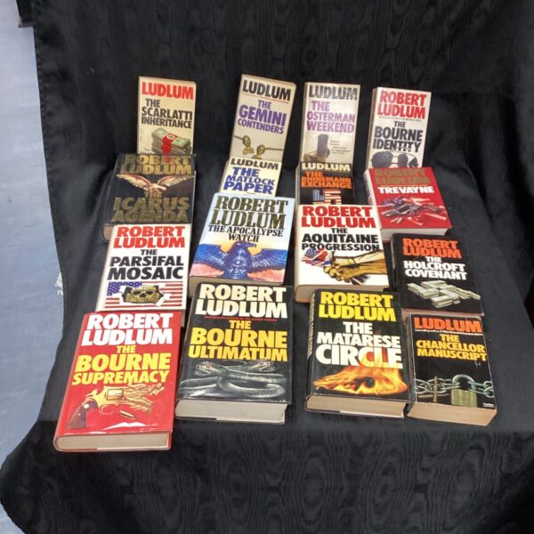Robert Ludlum book lot featuring several thriller novels.