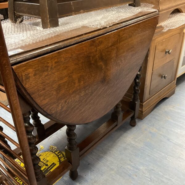 Antique drop leaf table with raised leaves and turned legs.