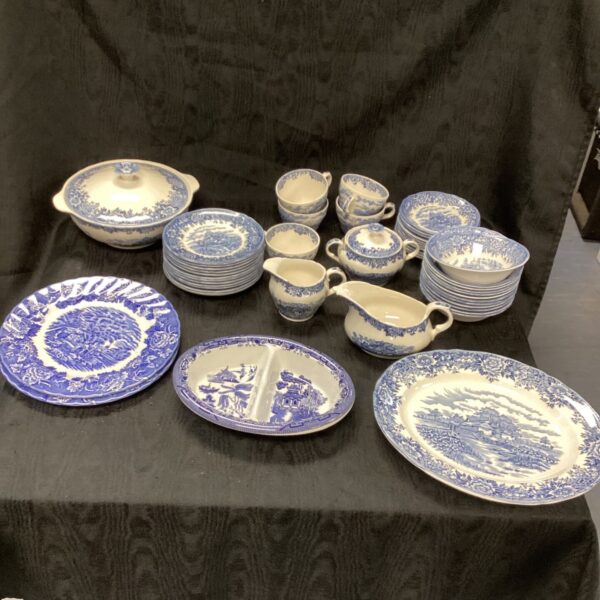 Full view of a large Blue Willow dinner service set.