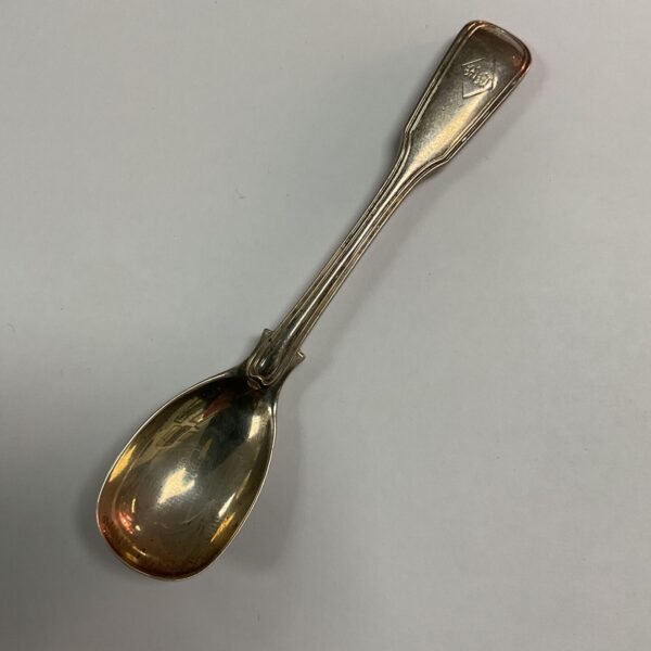 Antique gilt coal scuttle spoon with floral detail.