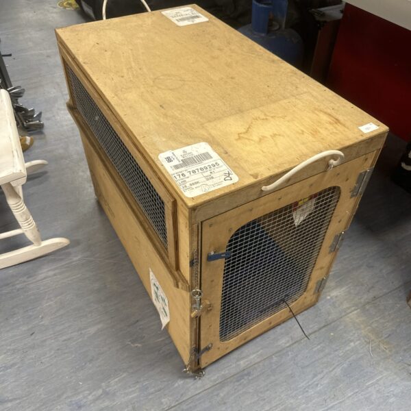 Wooden air cargo kennel by Dubai Kennels, showing signs of use.