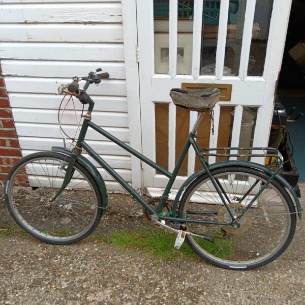 Vintage ladies bicycle awaiting restoration, classic cycling.