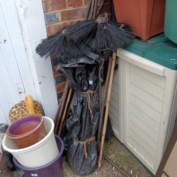 Bundle of vintage chimney sweep brushes for hearth cleaning.
