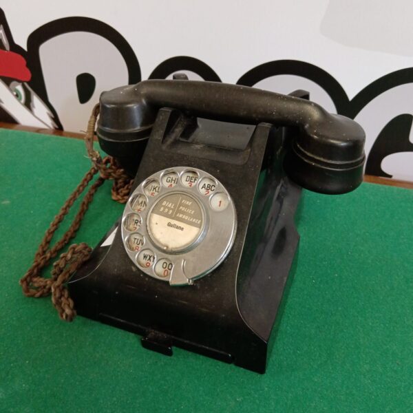 Dark vintage bakelite rotary telephone, model 332L.
