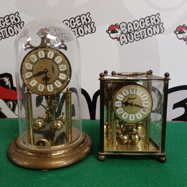 Antique carriage clock and Rallez domed clock on display.