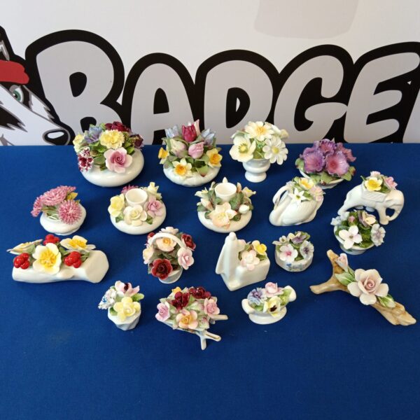 Vintage porcelain flower collection with delicate floral details.