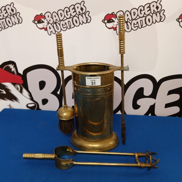 Vintage brass fireplace companion set with shovel, poker, and tongs.