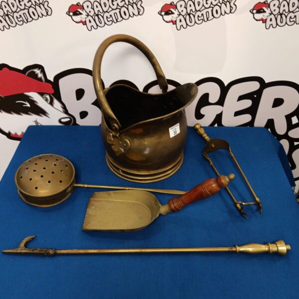 Vintage brass fireplace companion set with scuttle and tools.