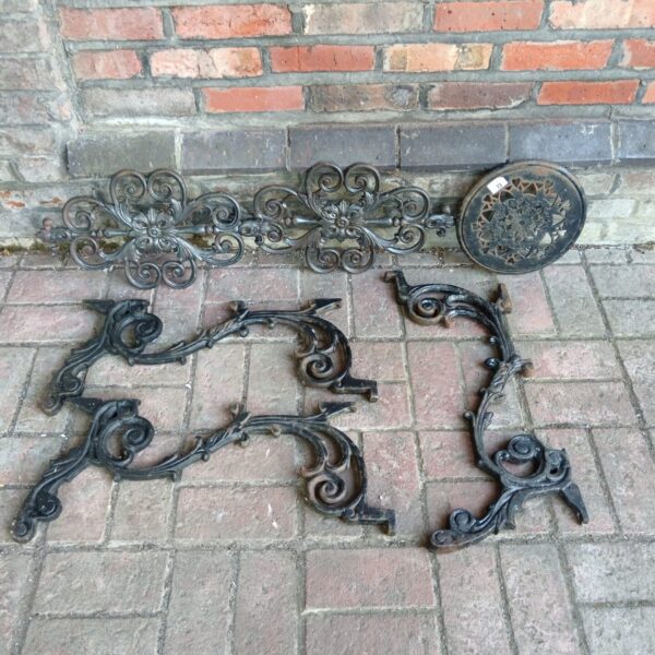 Ornate cast iron table legs and decorative panel with Victorian detailing.