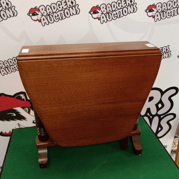 Antique mahogany gate leg table with drop leaf design.