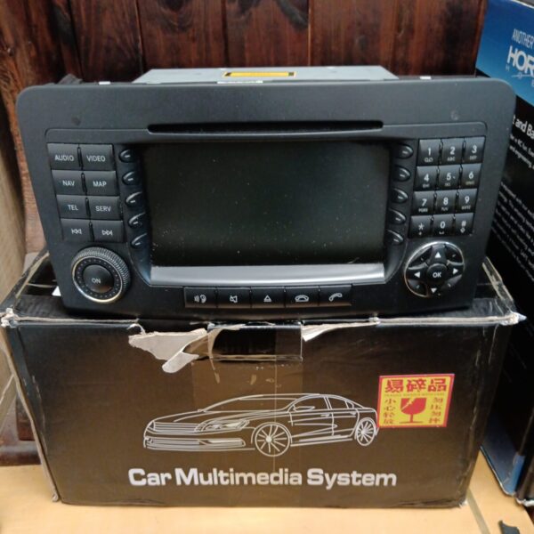 Front view of a vintage car multimedia system with buttons.