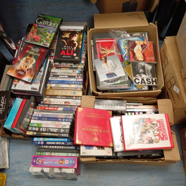 Mixed lot of DVDs and CDs for entertainment collection.