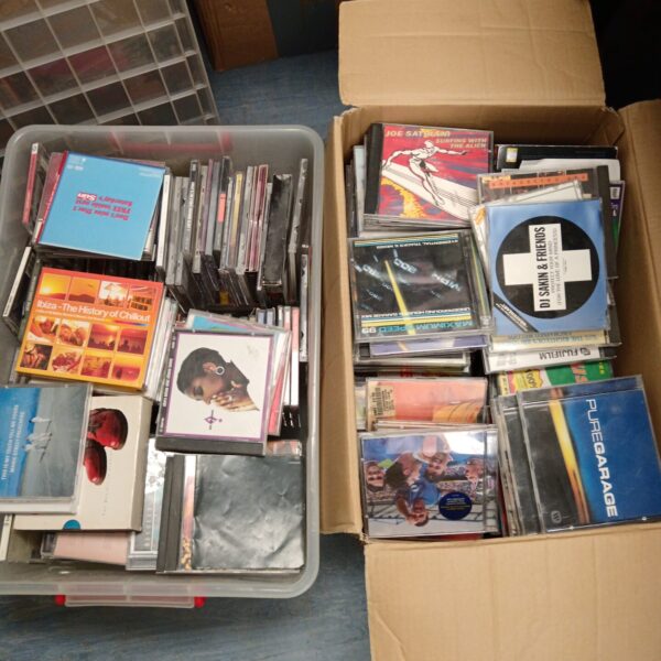 Large boxes filled with a diverse music CD collection.