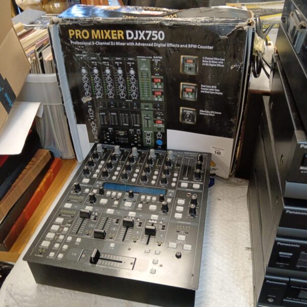 Behringer DJX750 professional DJ mixer with controls visible.
