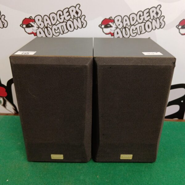 Pair of vintage Sony ss-p11 stereo speakers on a green background.