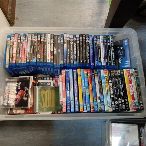 Blu-ray and DVD movie lot in a plastic container.
