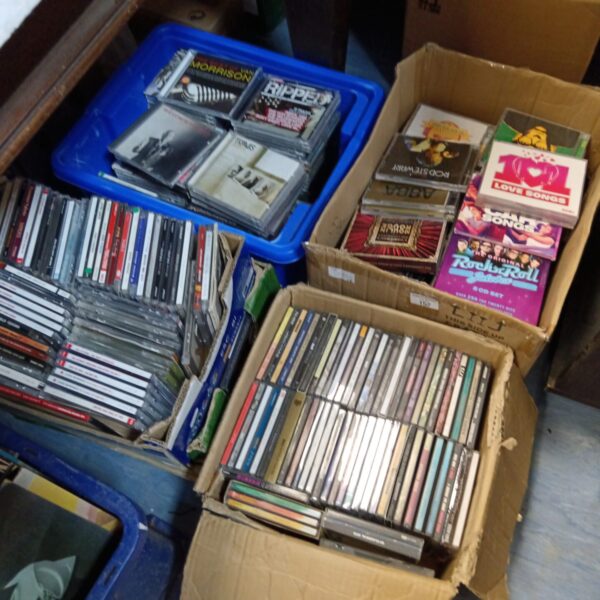 Large lot of music CDs in storage boxes.