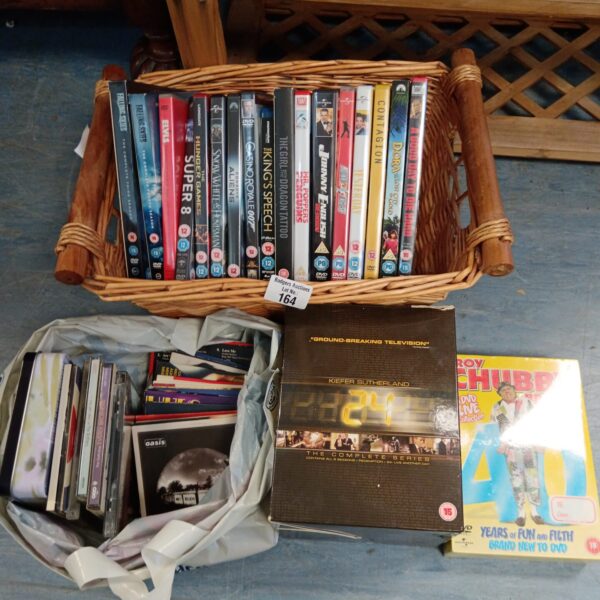 Woven basket filled with DVDs and music CDs, including 24 boxset.