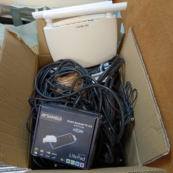 Sansui Smart Android TV box with HDMI cables and power supplies.