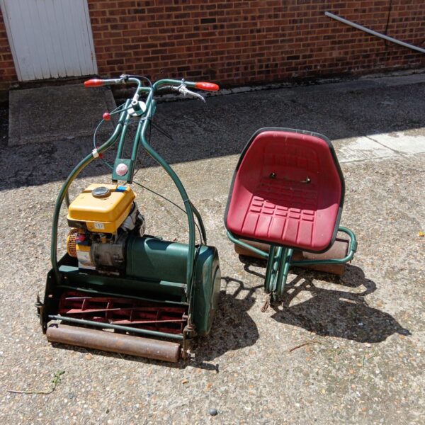 Vintage Webb petrol lawn mower with roller seat attachment.
