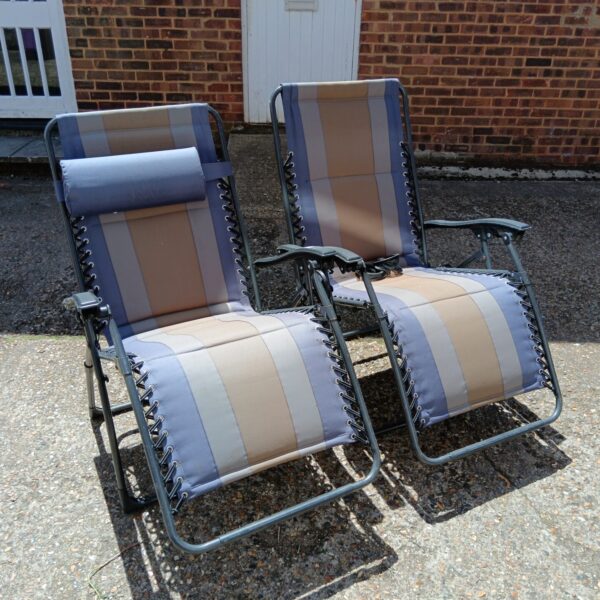 Striped garden recliner chairs for outdoor relaxation.