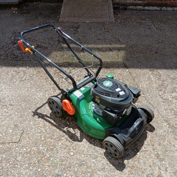 Front view of a vintage Hawksmoor petrol lawnmower in a garden.