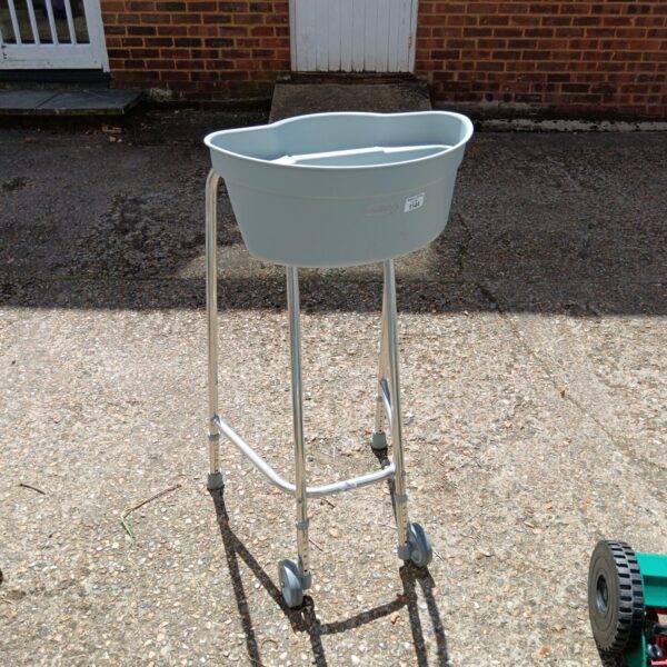 Silver Buckingham Mobility walker caddy on a paved surface.