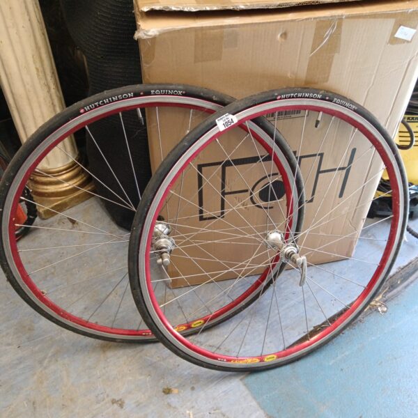 Pair of silver Mavic bike wheels with quick release mechanisms.