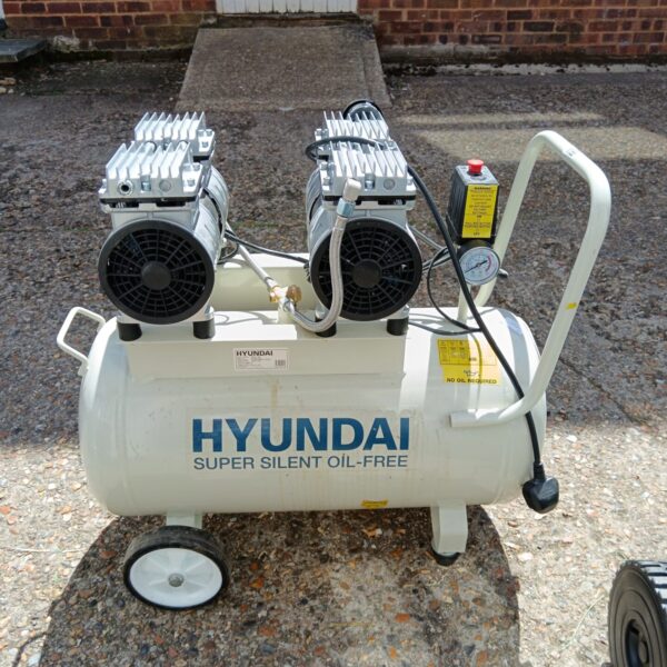 Portable Hyundai air compressor with wheels for easy movement.