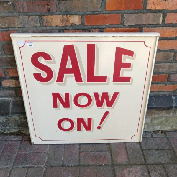 Vintage cream and red wooden sale sign for collectors.