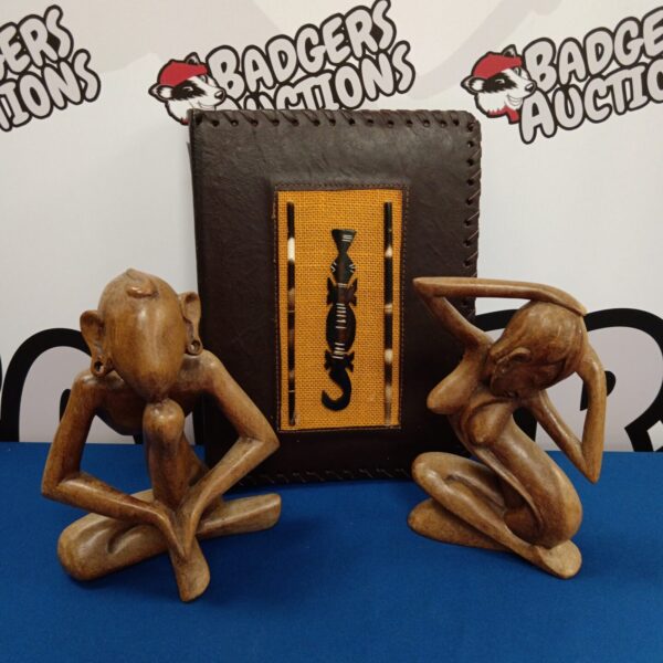 Vintage photo album and African carved wooden figures on display.