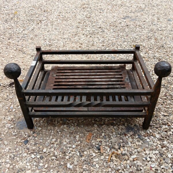 Antique wrought iron fireplace basket with ball finials.