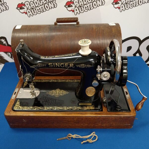 Antique Singer y8378671 hand crank sewing machine in wooden base.