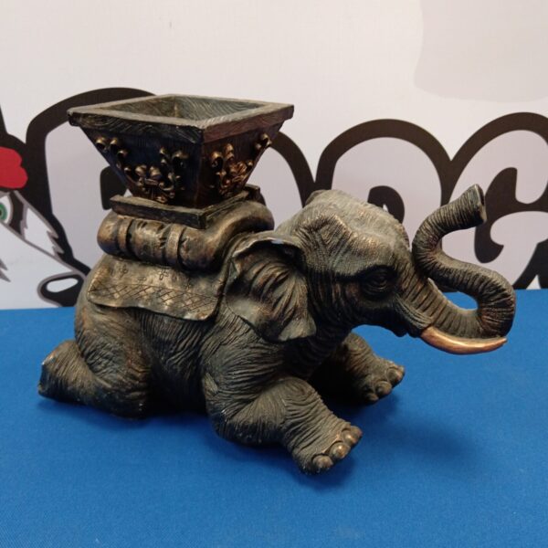 Detailed resin elephant candle holder for home decor.