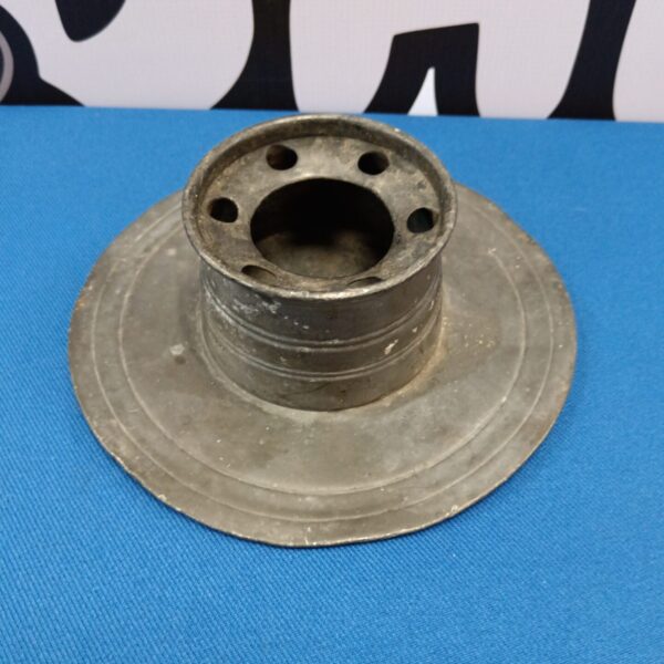 Antique pewter inkwell with aged patina on a dark surface.