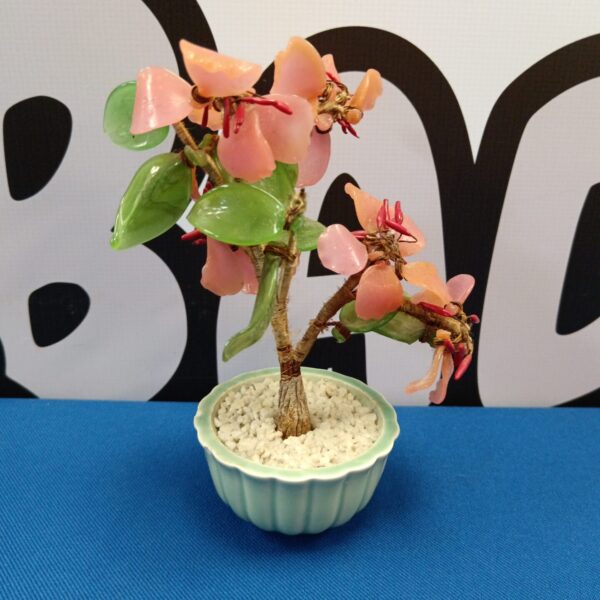 Vintage Chinese stone blossom tree with delicate pink blossoms.
