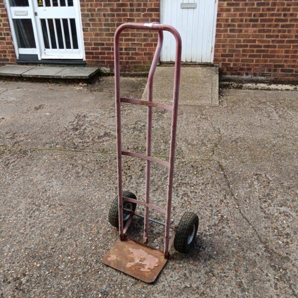 Heavy duty sack barrow with a single wheel for moving loads.