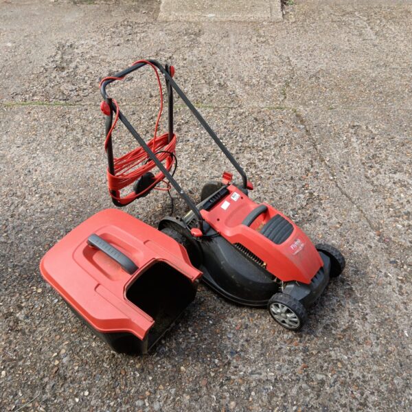 Red Flymo Speedi Mo 360c electric lawnmower in used condition.