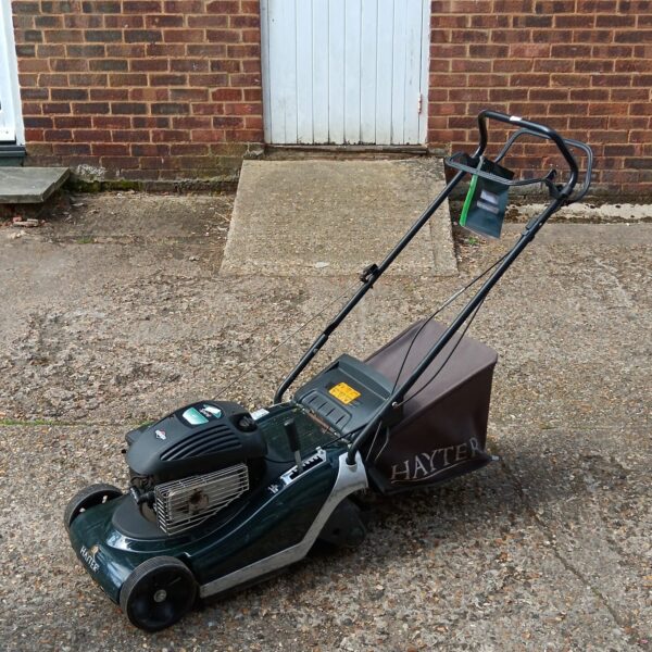 Hayter Spirit 41 petrol lawnmower in a garden setting.