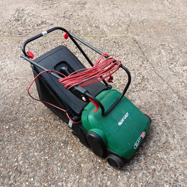 Qualcast Elan 32 electric lawnmower in a garden setting.