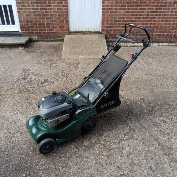 Hayter Harrier 41 petrol lawnmower in a garden setting.