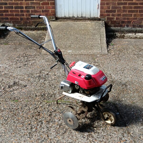 Used Honda F210 rotavator for garden cultivation.